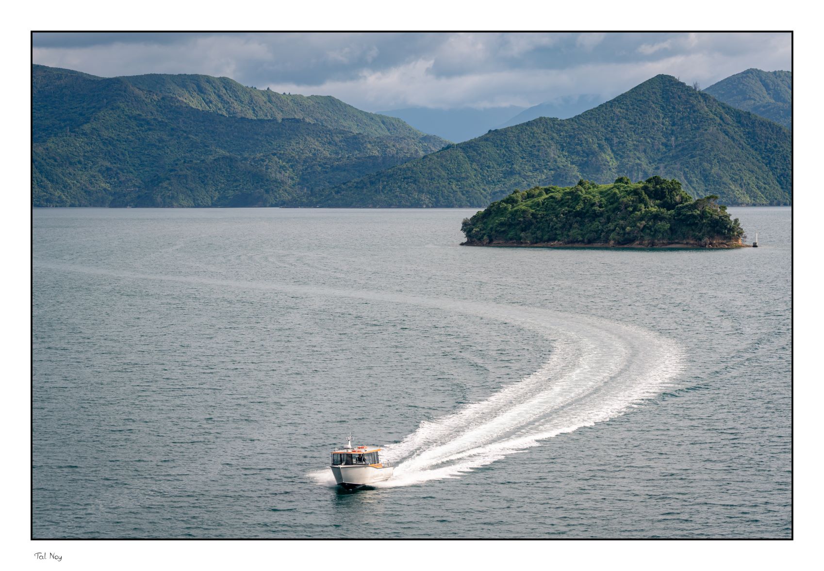 Cruising - boat cruising through dramatic fiord scenery